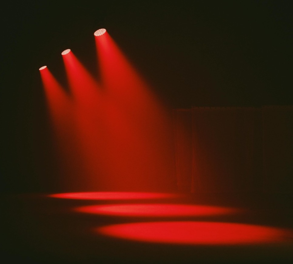 Red stage spotlights in a dark room